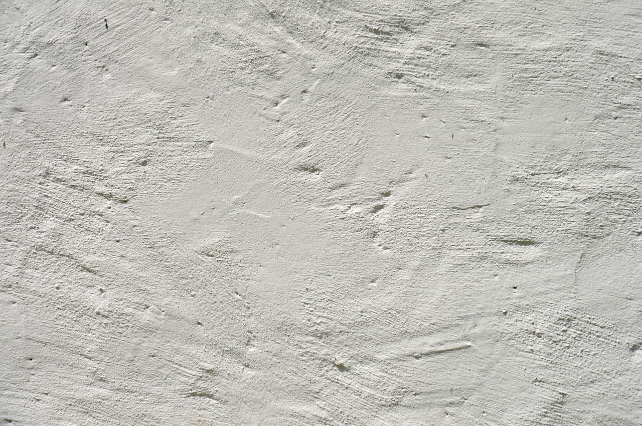 Close-up of a hand-trowelled white plaster wall